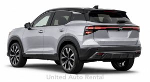Silver Nissan Kicks compact SUV rental shown from a 45-degree rear angle at United Auto Rental in Orange County and Ontario, California.